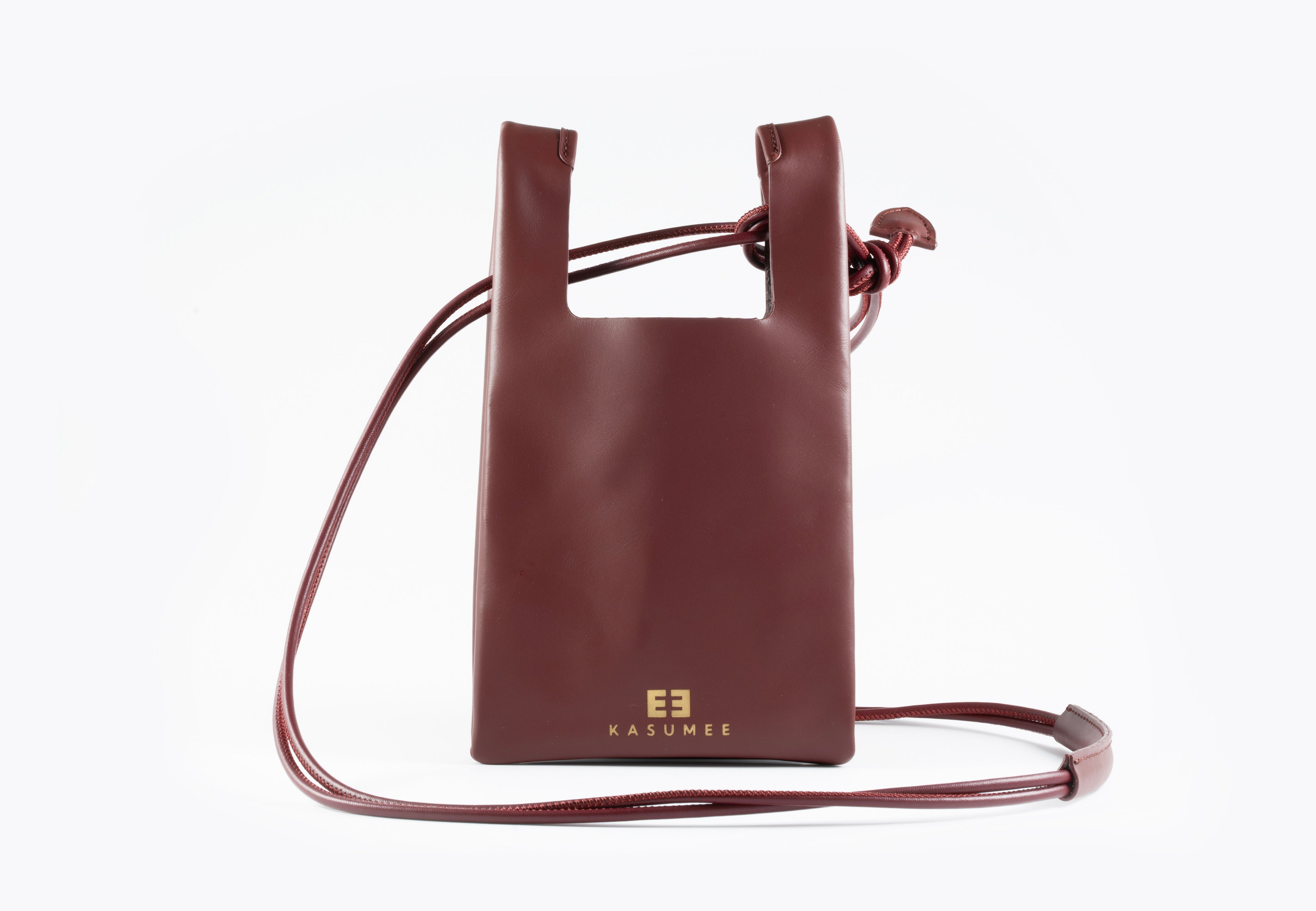 Burgundy leather crossbody bag on a white background