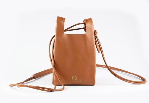 Caramel brown small leather crossbody phone bag by KASUMEE, front view with gold logo and thin leather strap